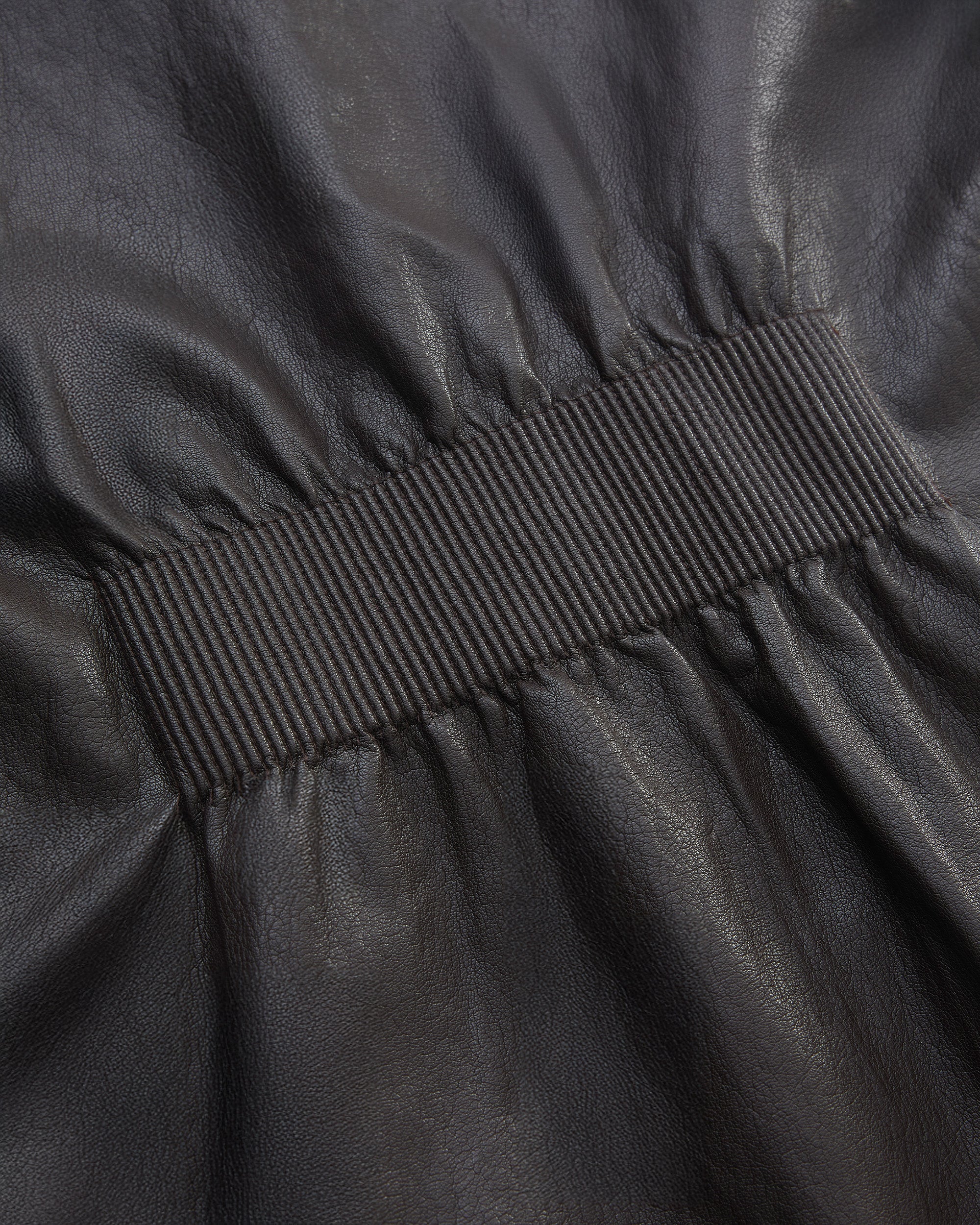 BACK PLEATED FAUX LEATHER COAT